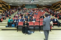 pexels photo 1709003 1709003 Professional setting of a business conference with attendees and a presenter in an auditorium.
